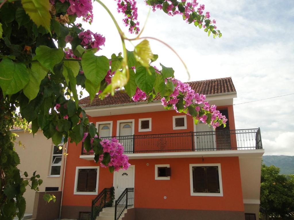 a house with pink flowers in front of it at Villa Agava in Vrboska