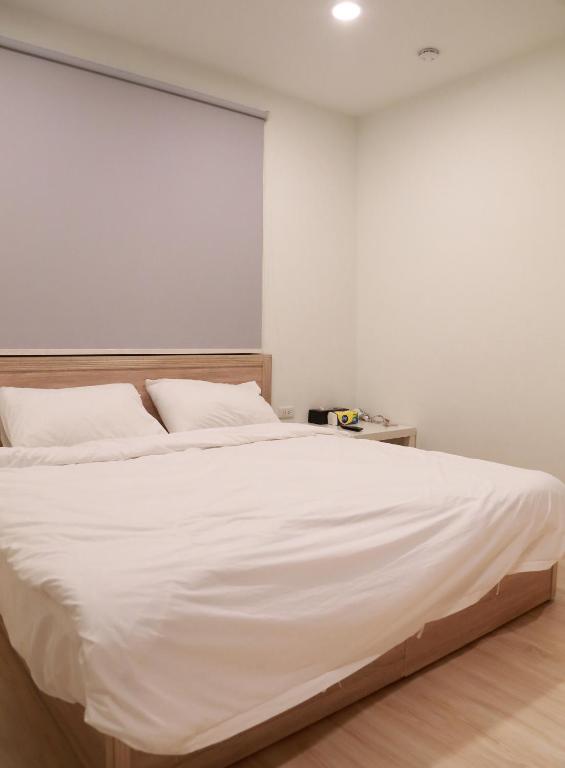 Postel nebo postele na pokoji v ubytování Donghai Cottage Backpack Inn Suite