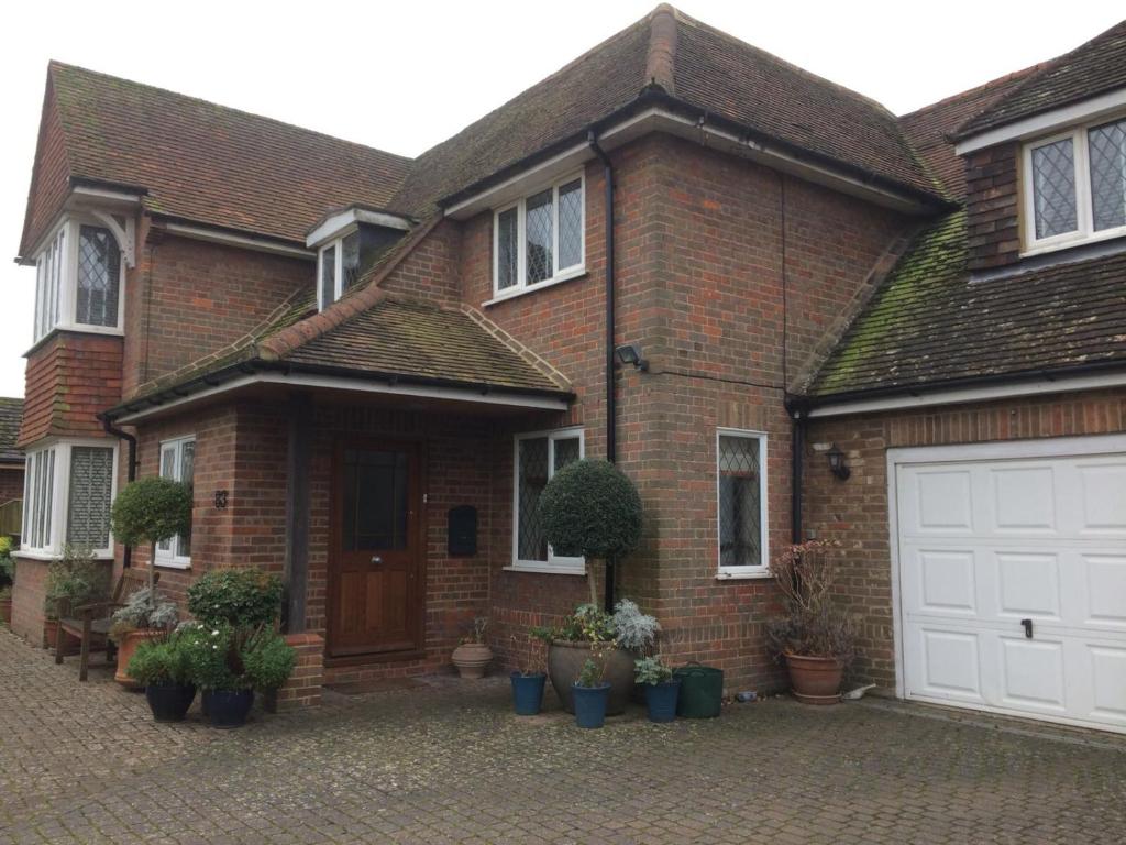 a brick house with a white garage at 83 in Aylesbury