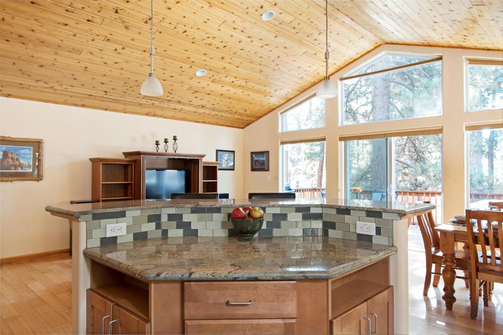 an open kitchen with a large island in a house at North Shore - Golden Pine in Kings Beach