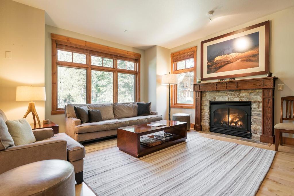 a living room with a couch and a fireplace at Cabins 13 in Old Mammoth