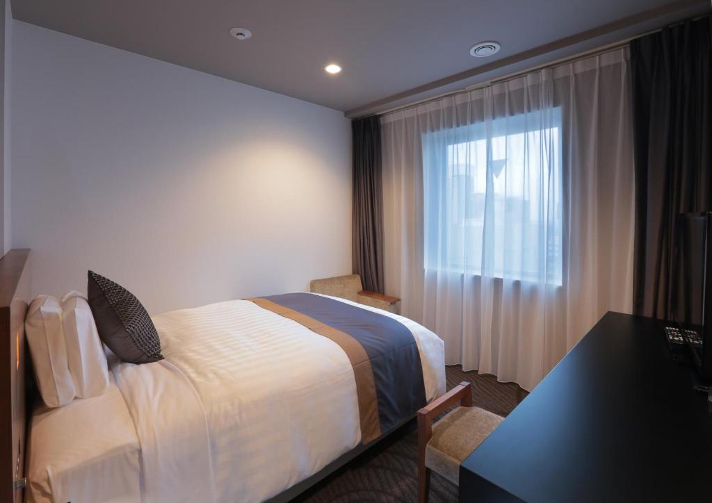Postel nebo postele na pokoji v ubytování Kisarazu Washington Hotel