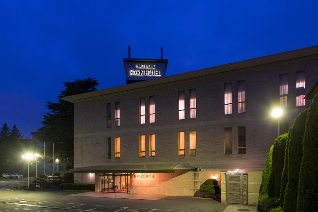 a building with a sign on top of it at night at Hachinohe Park Hotel in Hachinohe