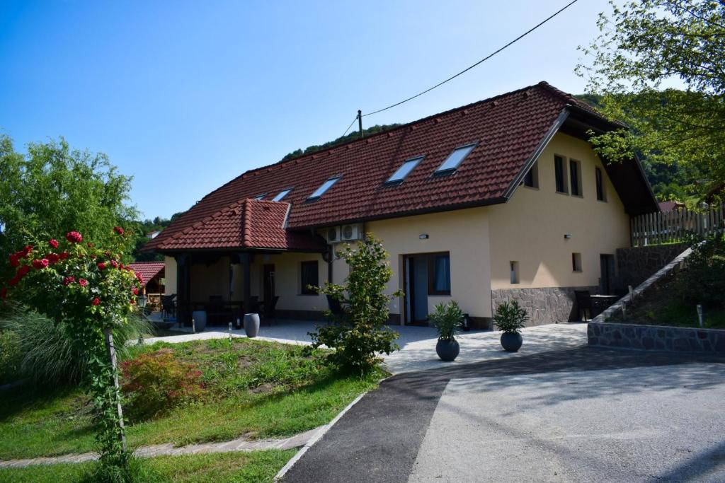 a house with a red roof and a driveway at Farm Stay Zevnik in Brežice