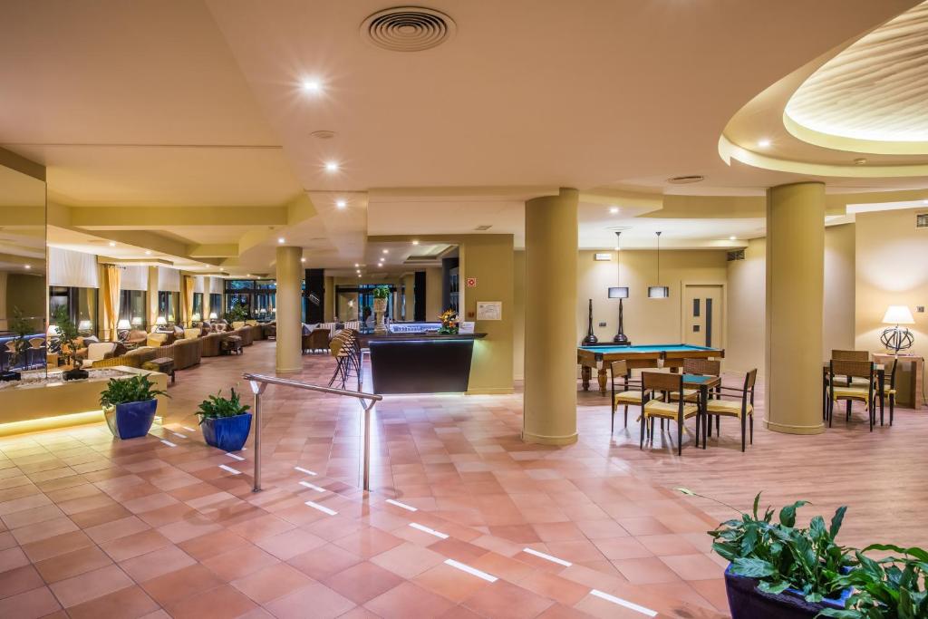 a lobby of a hotel with tables and chairs at Calheta Beach - All-inclusive - Savoy Signature in Calheta