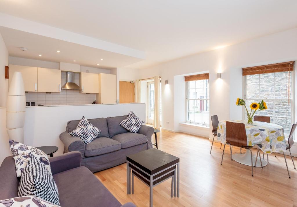 a living room with a couch and a table at The Edmonstone's Close Residence in Edinburgh