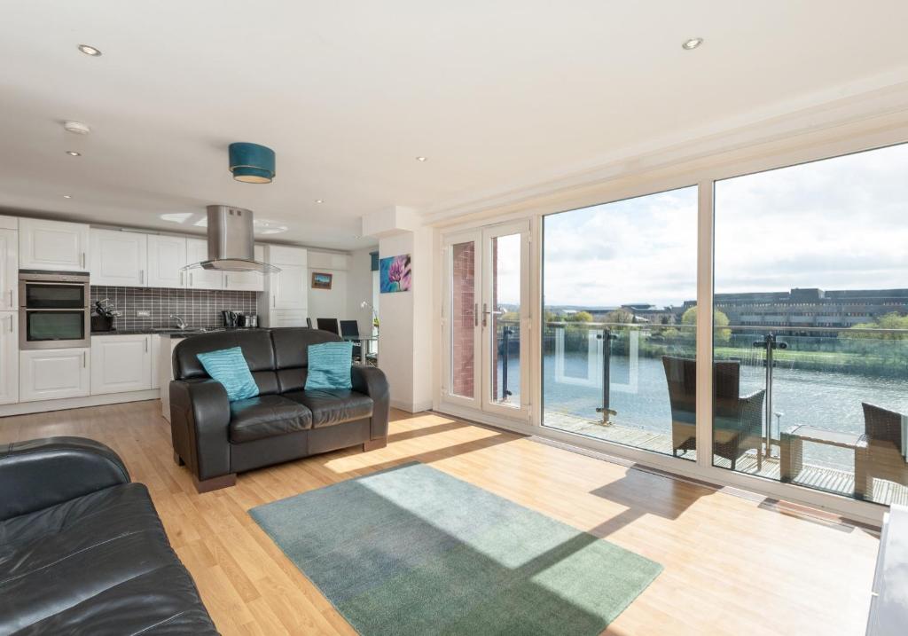 a living room with a view of the water at The Metropole Residence in Glasgow
