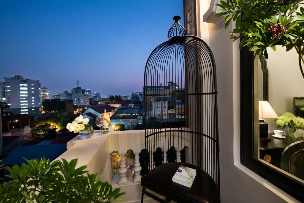 a bird cage sitting on top of a balcony at Hanoi Center Silk Premium Hotel & Spa & Travel in Hanoi