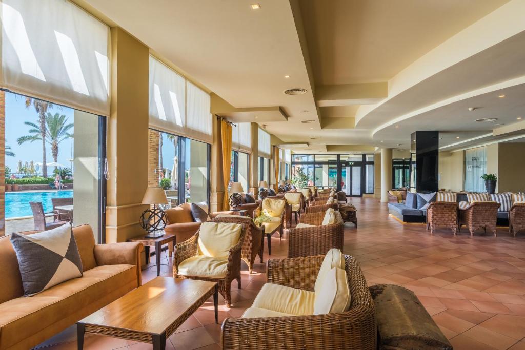 a lobby with couches and chairs and a pool at Calheta Beach - All-inclusive - Savoy Signature in Calheta