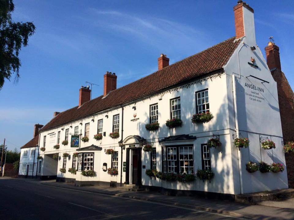 a white building on the side of a street at The Angel Inn (Blyth) in Blyth