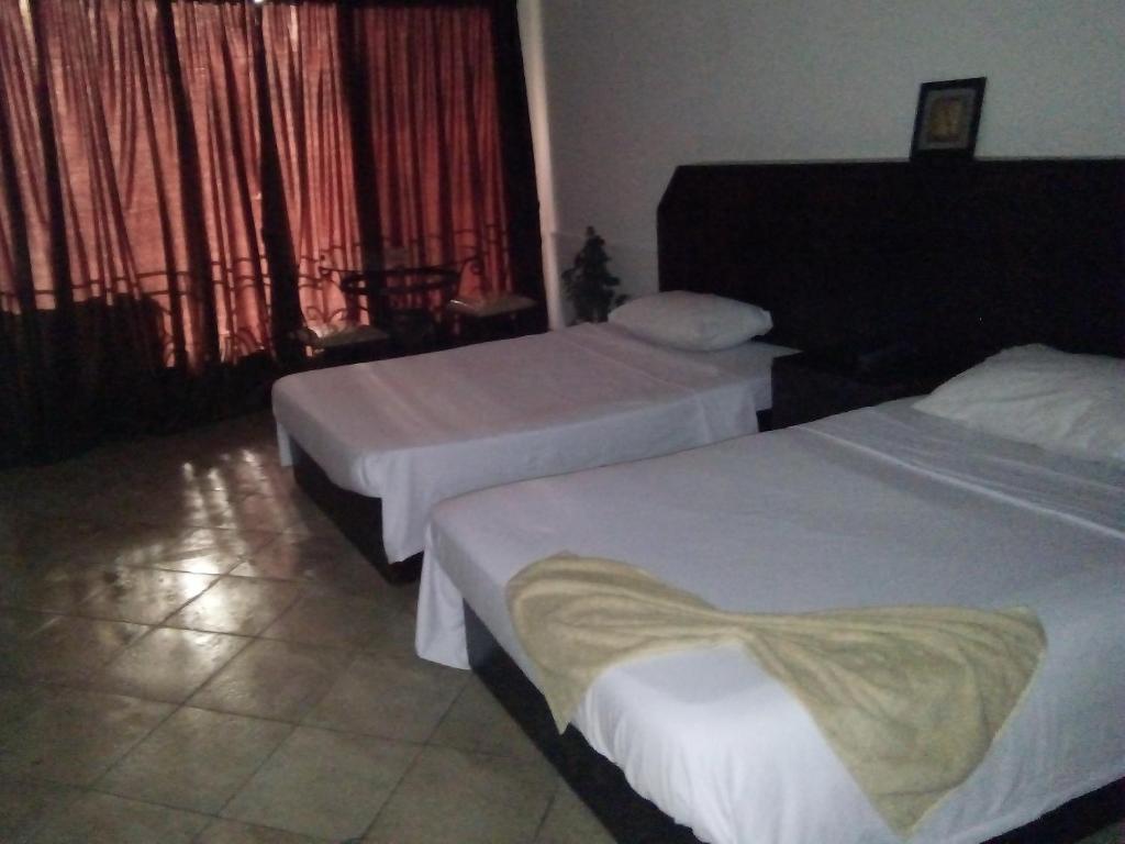 Postel nebo postele na pokoji v ubytování Arabesque Hotel