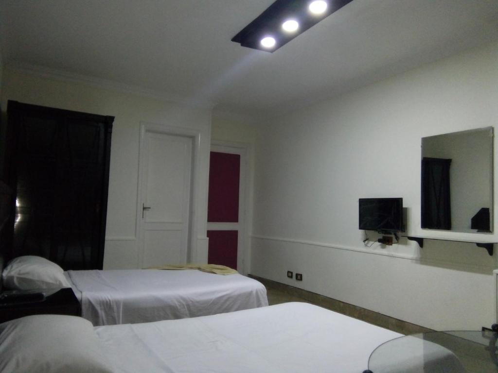 Postel nebo postele na pokoji v ubytování Arabesque Hotel