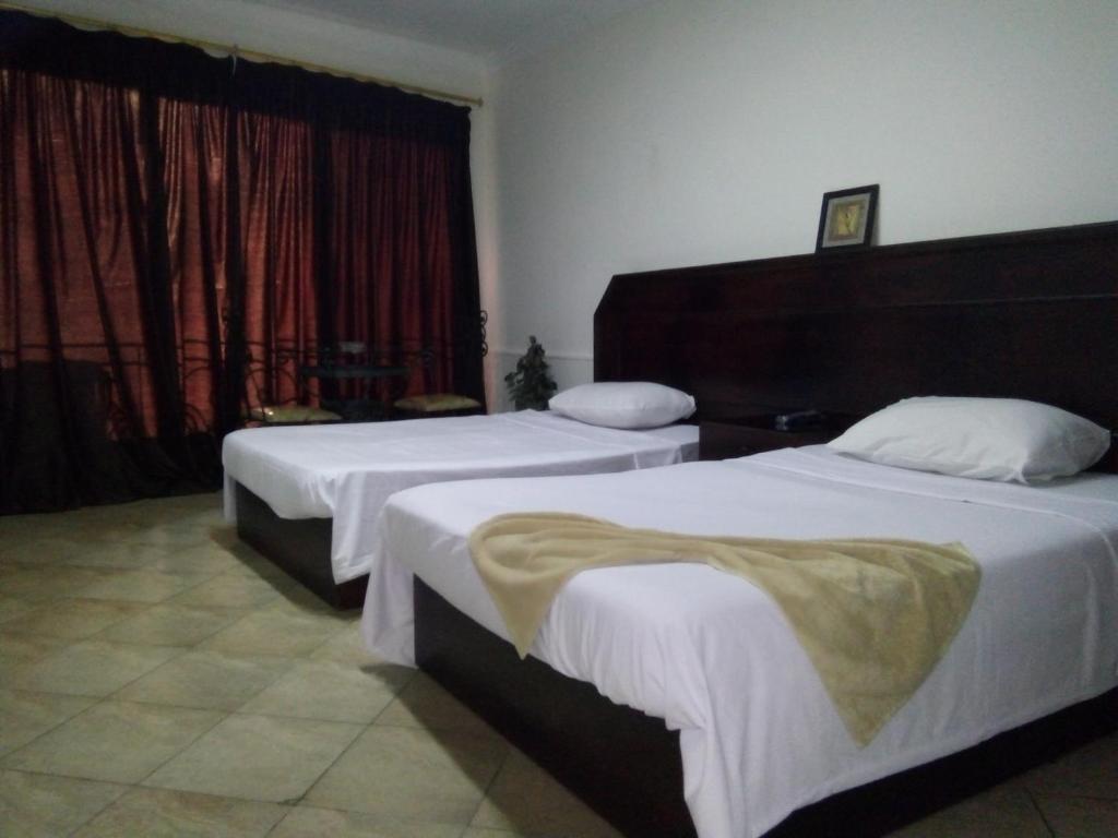Postel nebo postele na pokoji v ubytování Arabesque Hotel