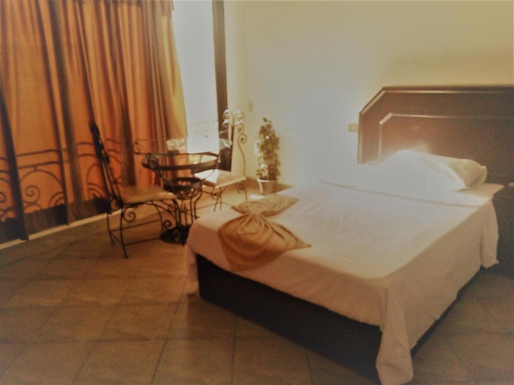 Postel nebo postele na pokoji v ubytování Arabesque Hotel