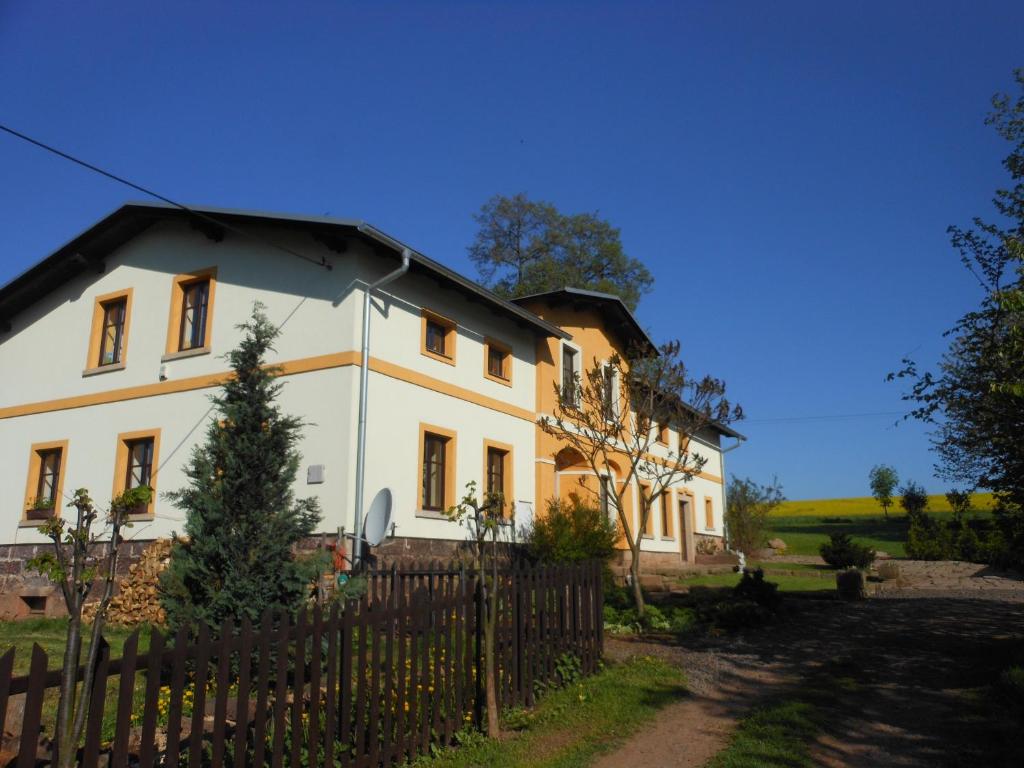 a large white house with a wooden fence at Chalupa Bozanov in Božanov