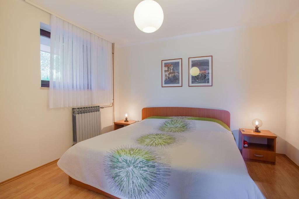 Postel nebo postele na pokoji v ubytování Apartments Ljubo & Lili