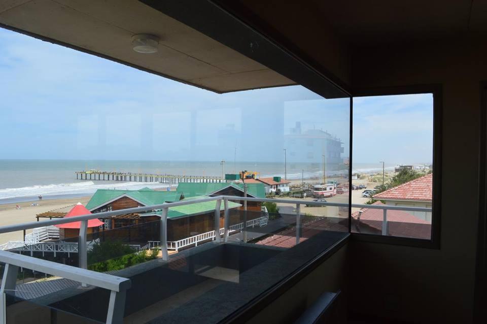 a balcony with a view of a beach and the ocean at Balcones Al Mar in Villa Gesell