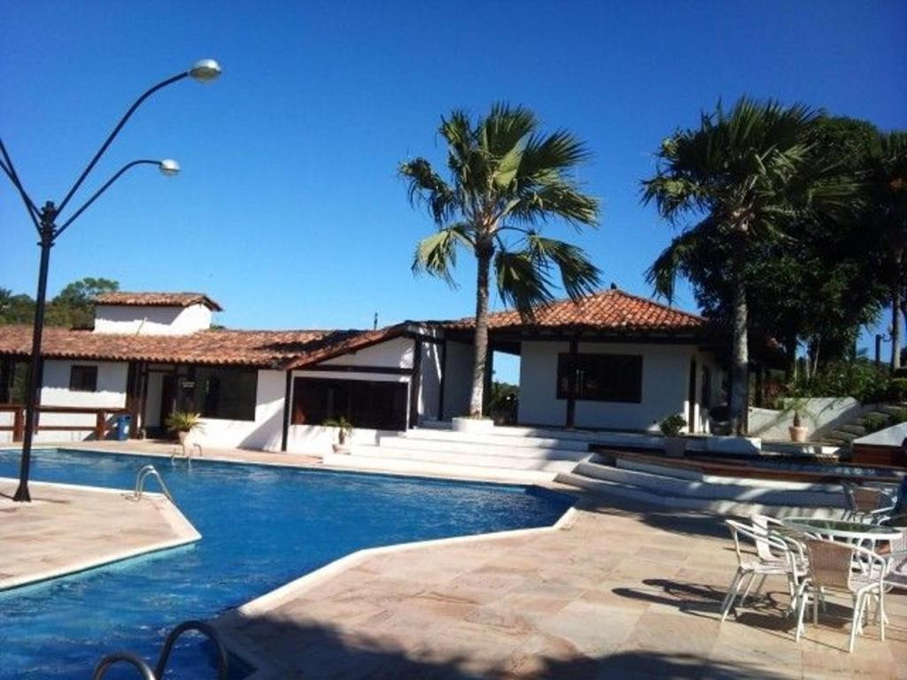a house with a swimming pool with palm trees at Geriba, casa de 4 qts charmosa com ar, DISPONIVEL CARNAVAL in Búzios
