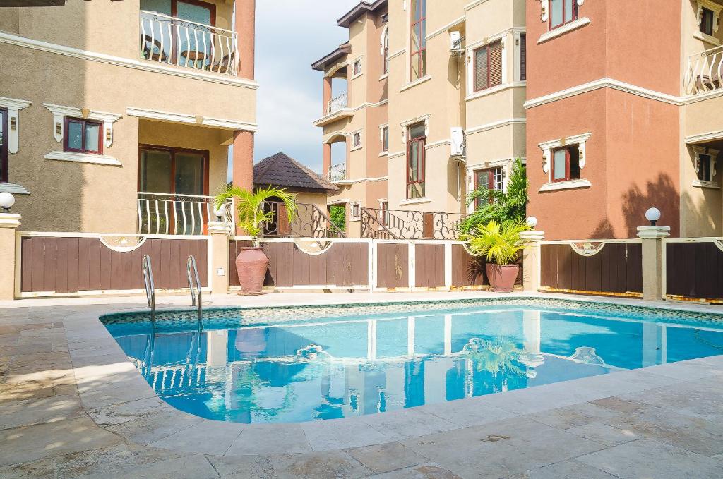 a swimming pool in front of a building at The Bellagio Getaway in Kingston