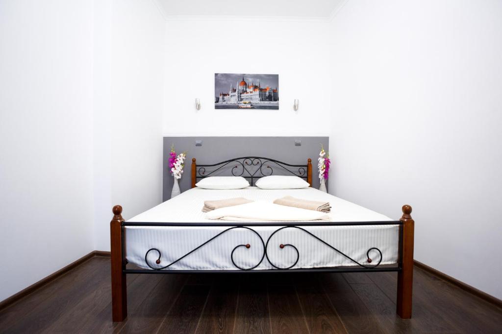 a bed in a room with a white wall at Furmanska 3 in Lviv