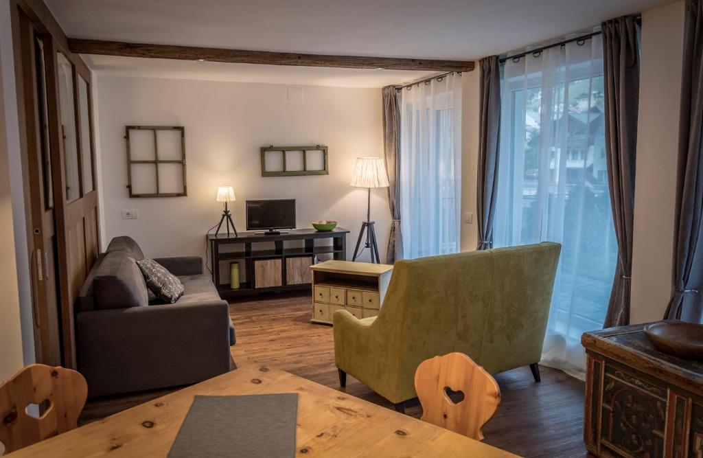 a living room with a couch and a table at Apartments N°7 in Ortisei