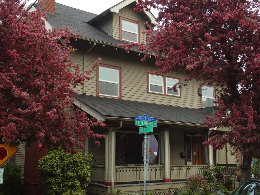 a house with a street sign in front of it at Portland International Guesthouse in Portland