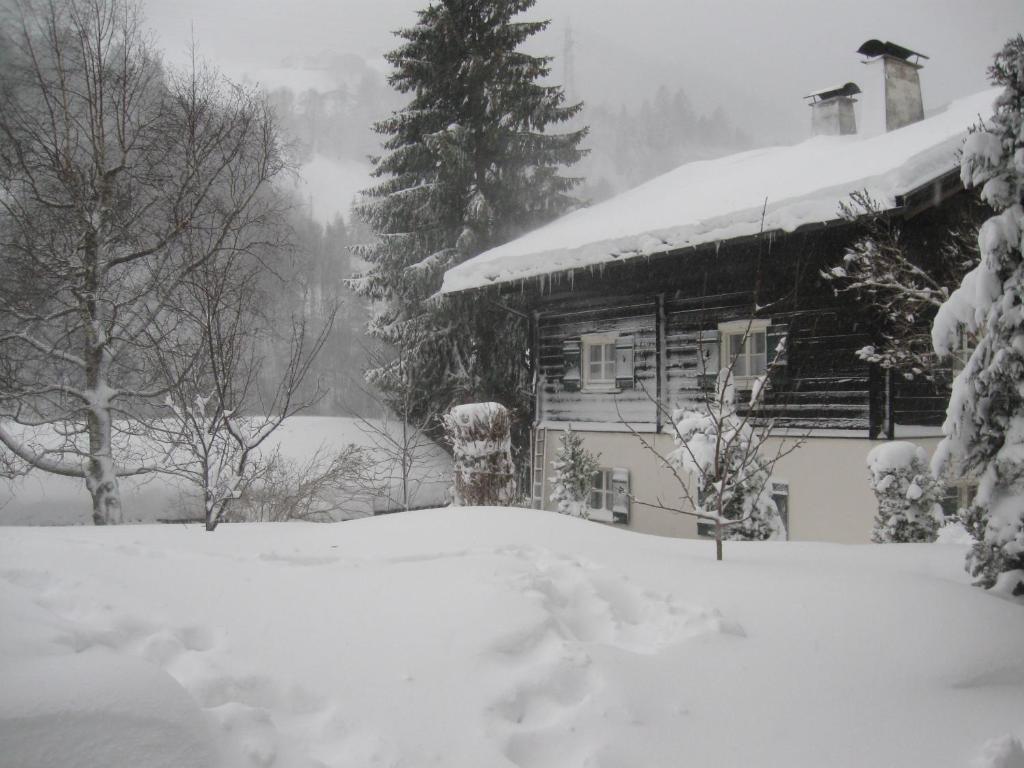 a house covered in snow in front at Haus Klinger in Gaschurn