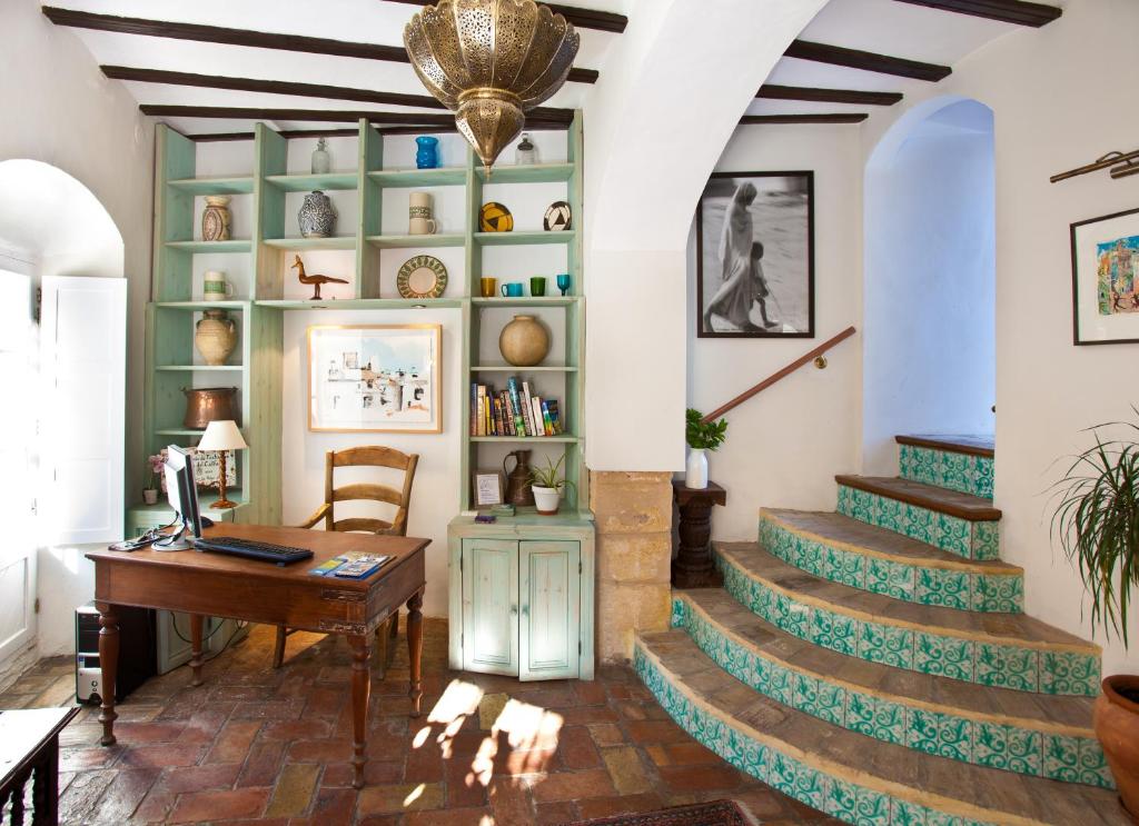 a home office with stairs and a desk at Hotel La Casa del Califa in Vejer de la Frontera