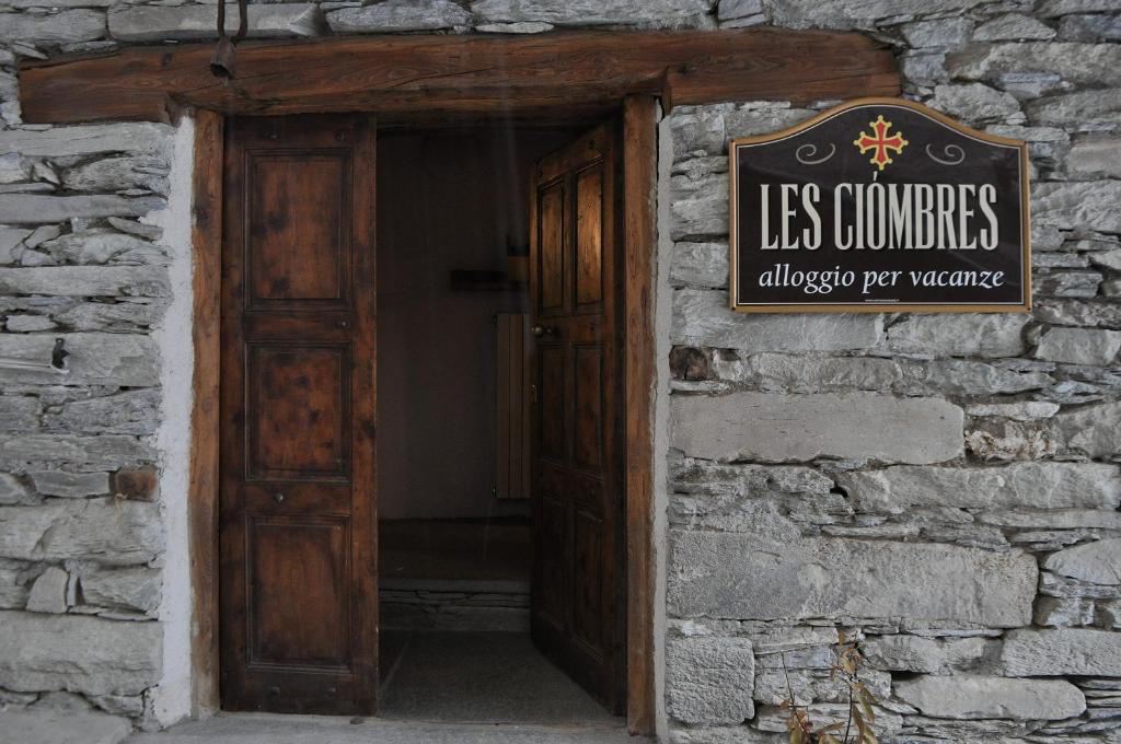 an open door of a building with a sign on it at L'Enventoour in Meleze