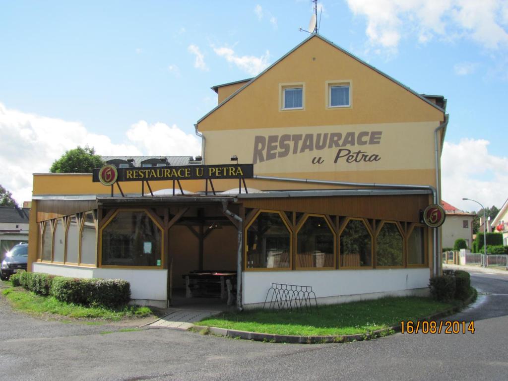 a building with a restaurant on the side of a street at Apartmány U Petra in Nová Role