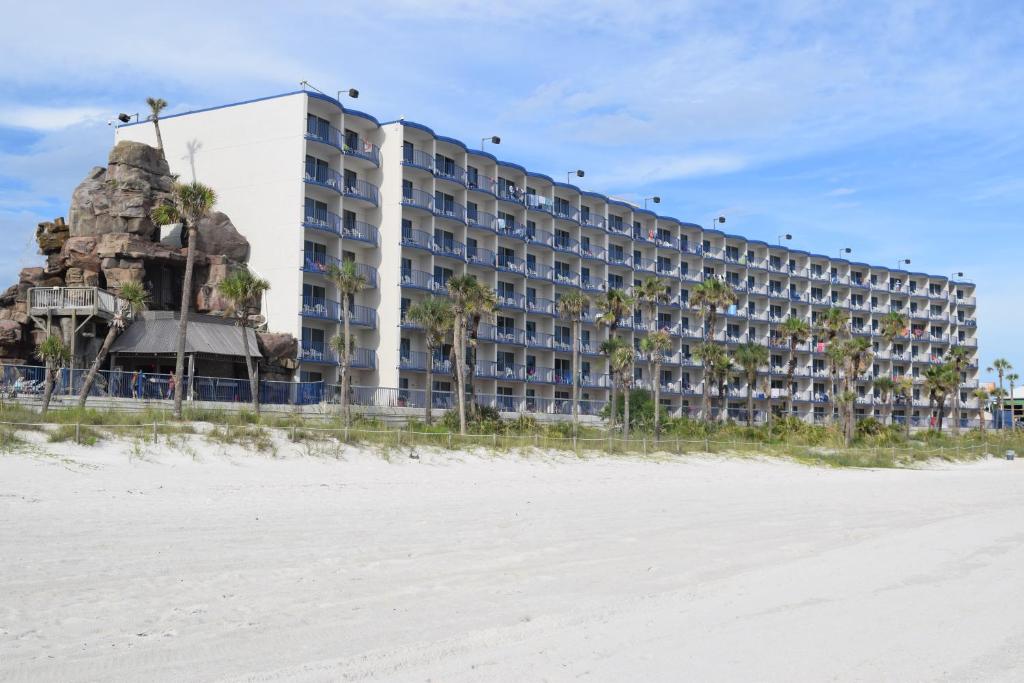 a large hotel on the beach with a beach at Days Inn by Wyndham Panama City Beach/Ocean Front in Panama City Beach
