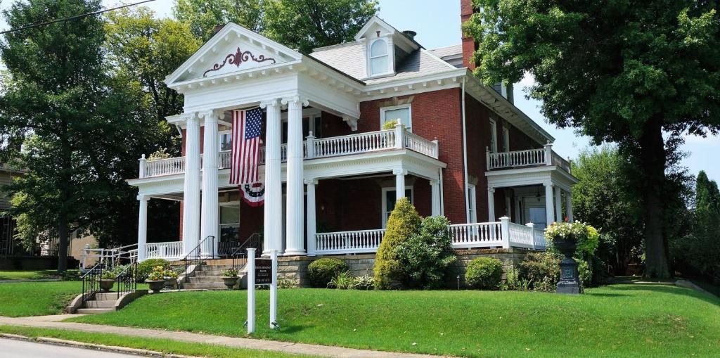 a red brick house with an american flag on it at South Broadway Manor in Scottdale