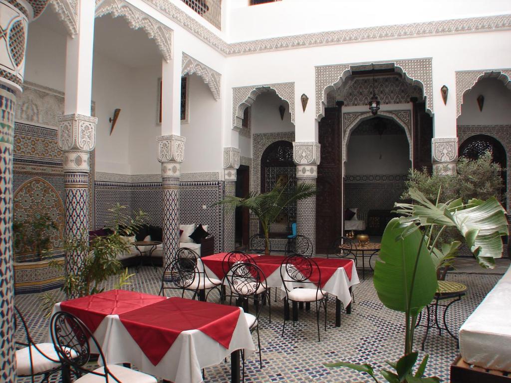 a courtyard with tables and chairs in a building at Riad Sheryne Fes in Fez