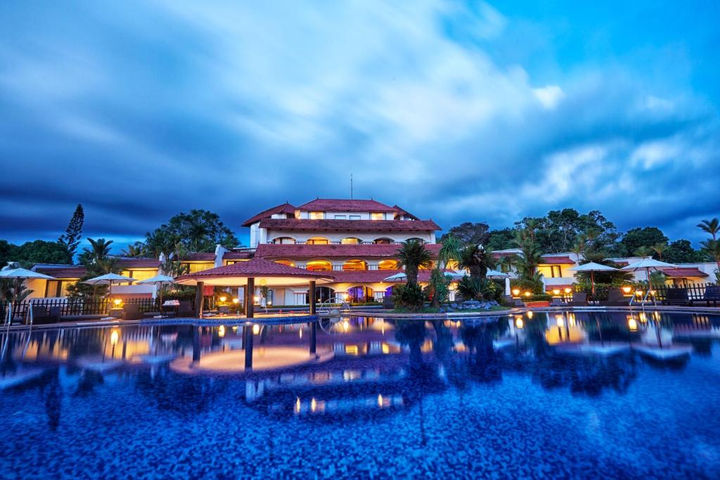 a resort with a large pool at night at Gateway Varkala - IHCL SeleQtions in Varkala