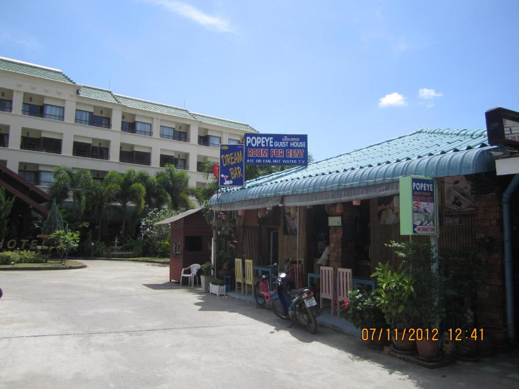 a building with bikes parked in front of a building at Popeye Guesthouse in Ao Nang Beach