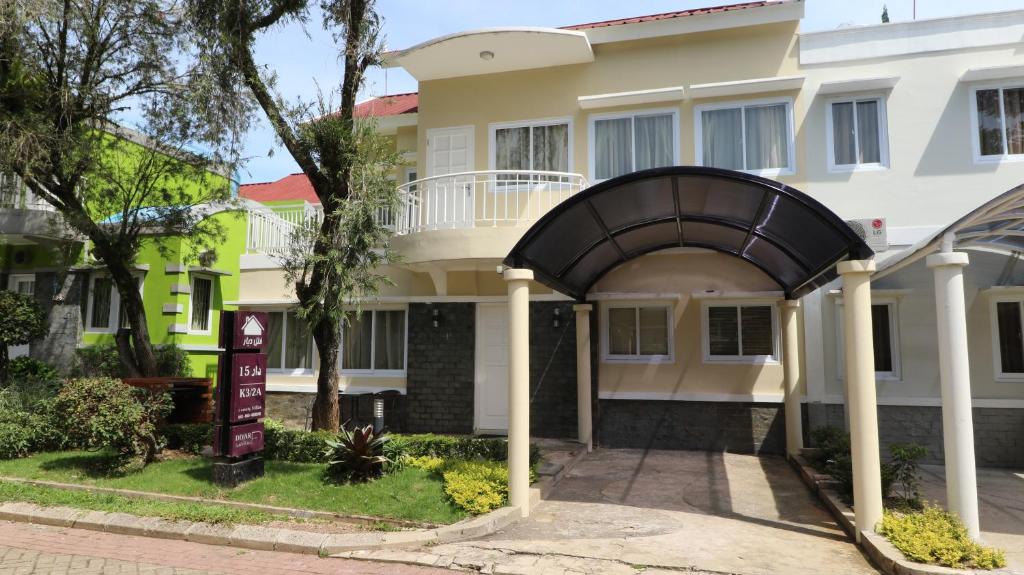 a building with an archway in front of it at Diyar Villas Puncak K3/2A in Puncak