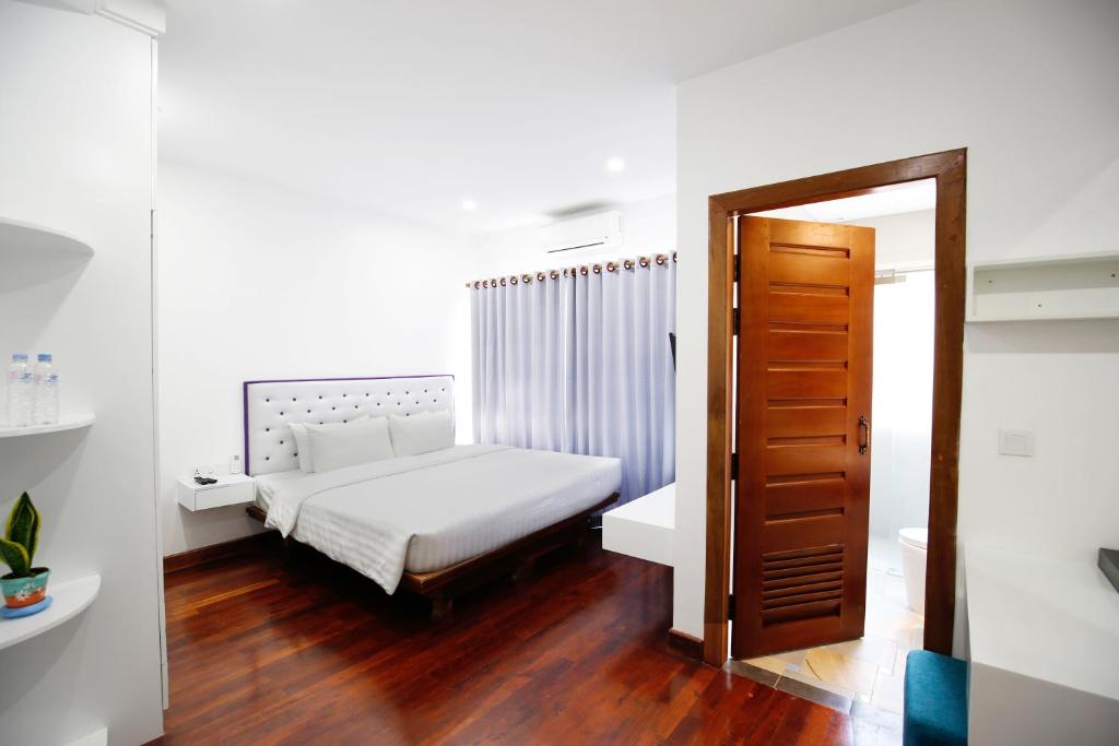 Postel nebo postele na pokoji v ubytování Zita Angkor Hotel