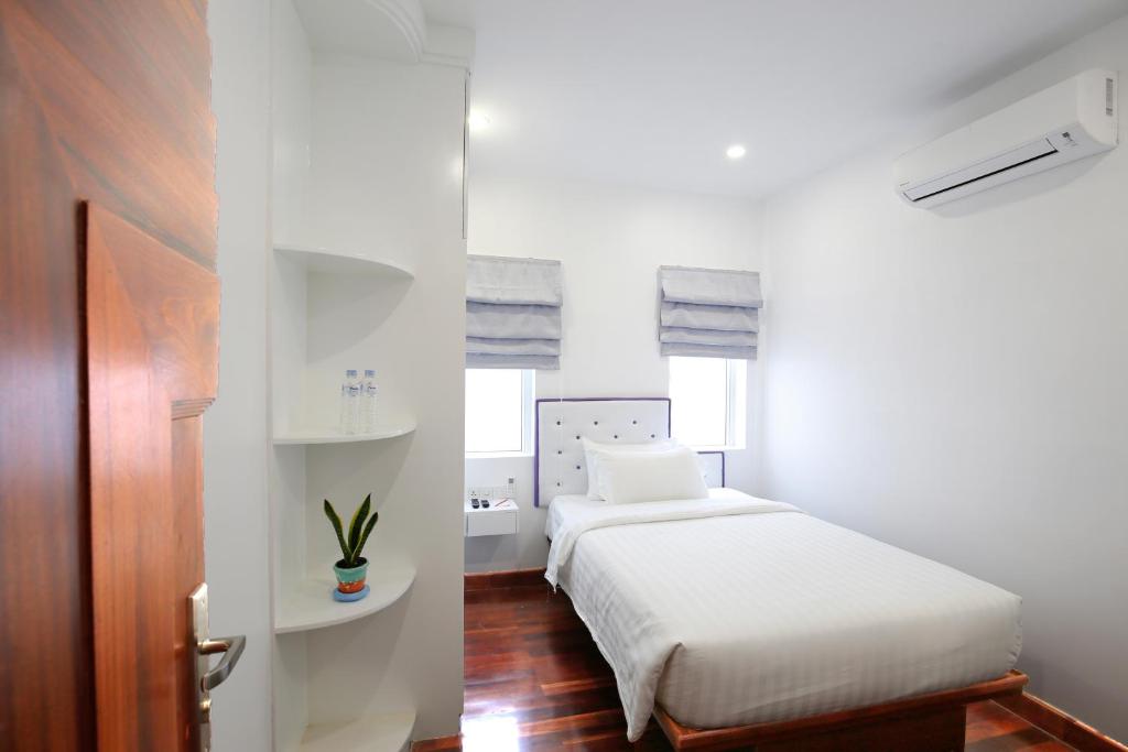 Postel nebo postele na pokoji v ubytování Zita Angkor Hotel