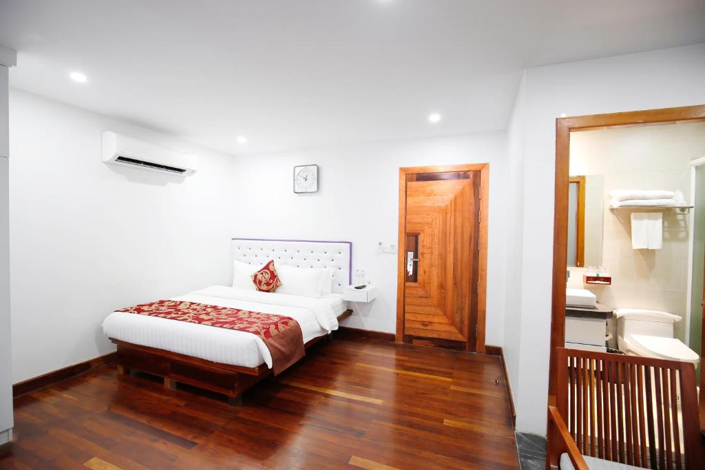 Postel nebo postele na pokoji v ubytování Zita Angkor Hotel