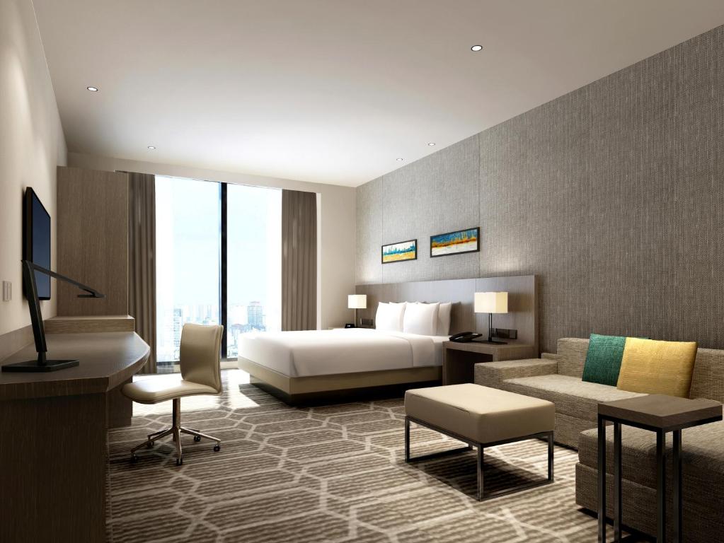 Postel nebo postele na pokoji v ubytování Hyatt Place Zhuhai Jinshi