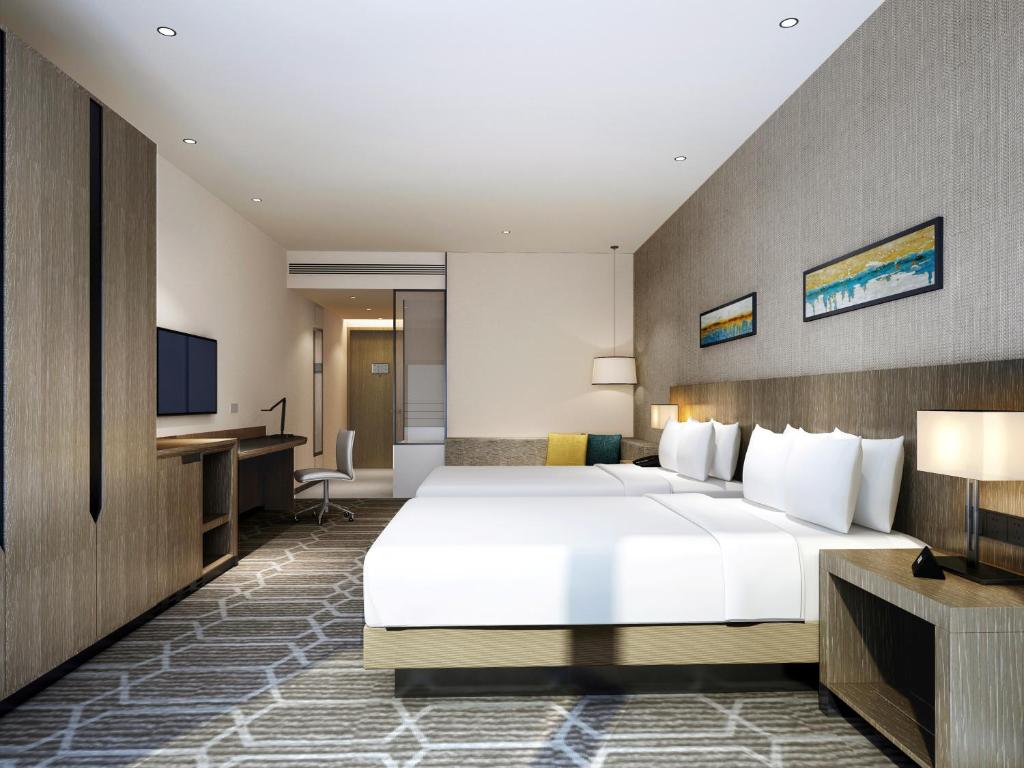 Postel nebo postele na pokoji v ubytování Hyatt Place Zhuhai Jinshi