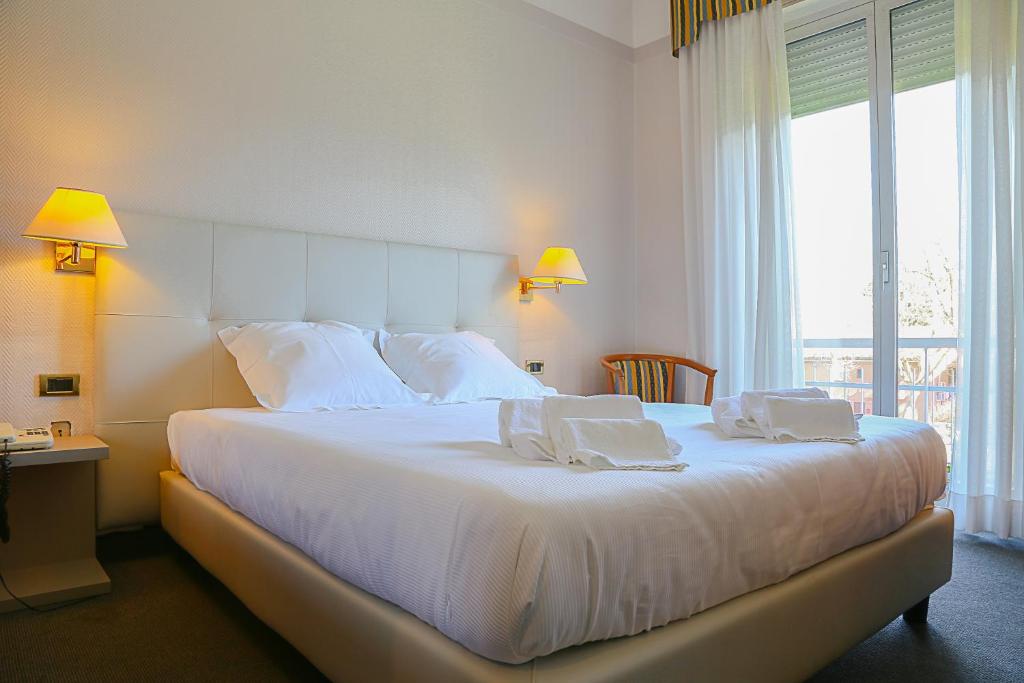 Postel nebo postele na pokoji v ubytování Hotel Augustus
