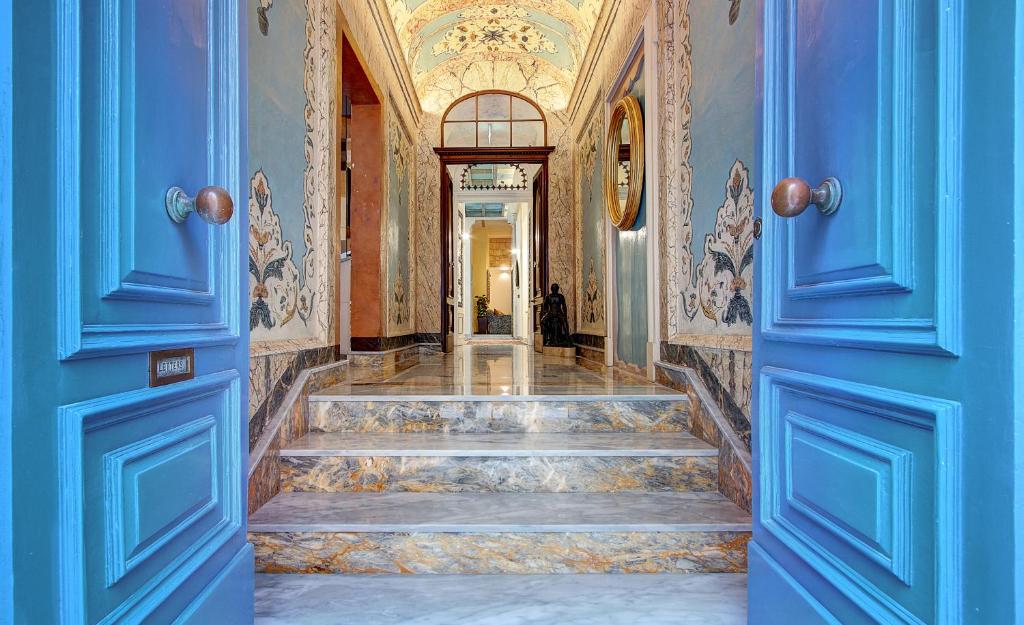 a blue door leading to a hallway with stairs at Palazzo Paolina Boutique Hotel in Valletta