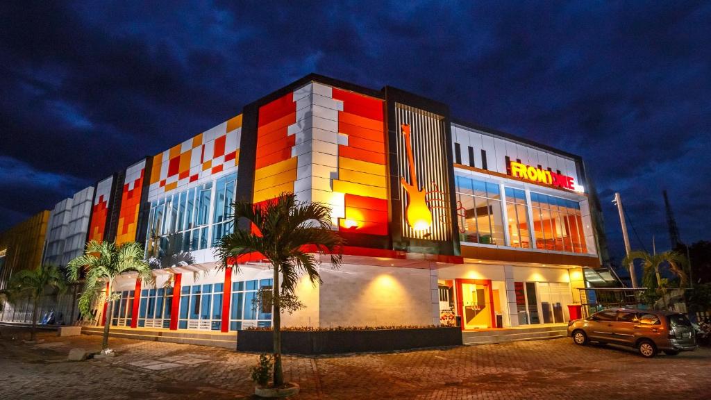 a building with a colorful facade at night at Front One Inn Muntilan in Muntilan