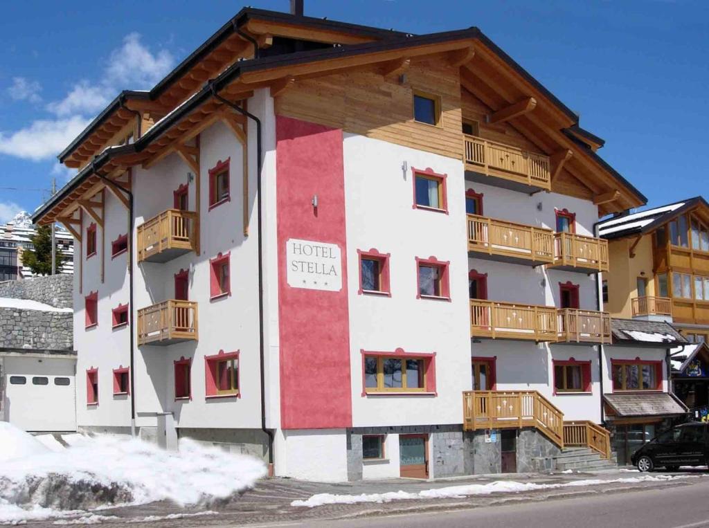 a apartment building with a red and white at Hotel Stella in Passo del Tonale