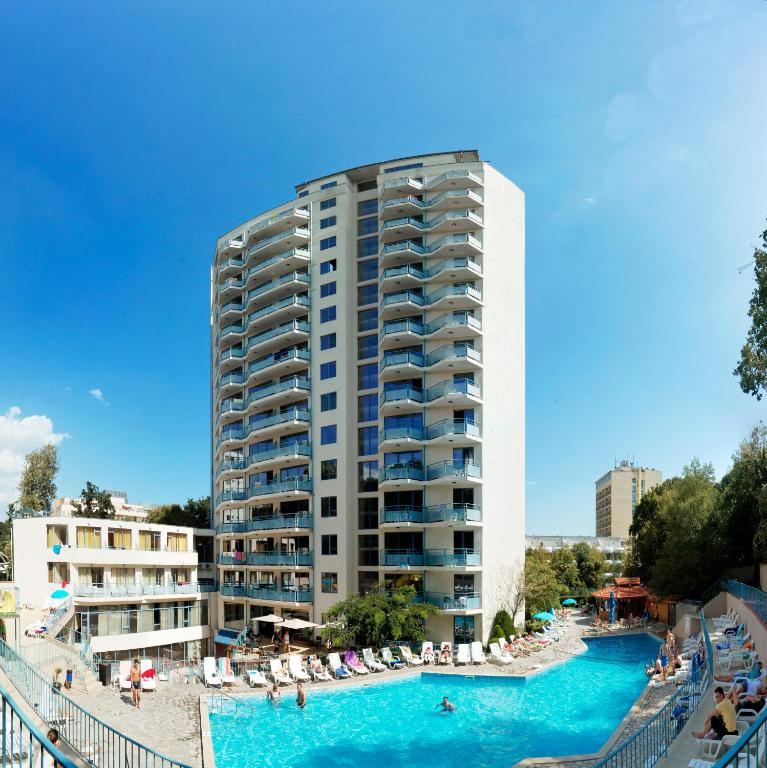 a large building with a swimming pool and a hotel at Hotel Rеgina - Golden Sands All Inclusive in Golden Sands
