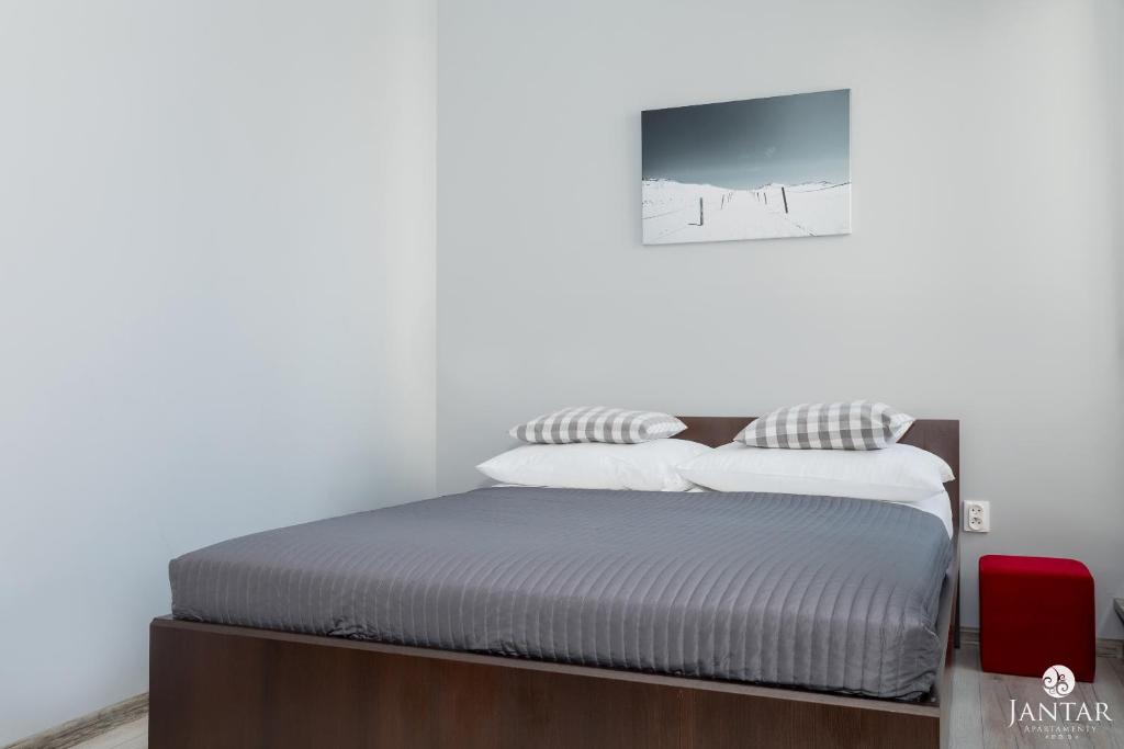 Posteľ alebo postele v izbe v ubytovaní Jantar Apartamenty Lighthouse Port Kołobrzeg