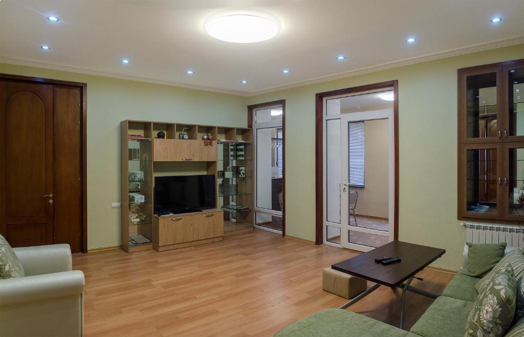 a living room with a couch and a tv at Lagidze Apartment in Tbilisi City