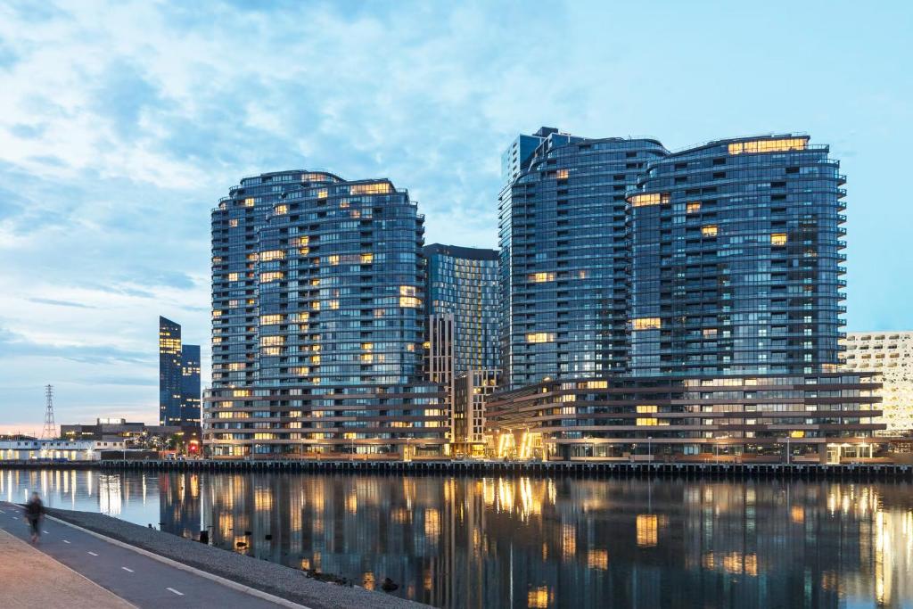 a city with tall buildings next to a body of water at Winston Apartments Docklands in Melbourne