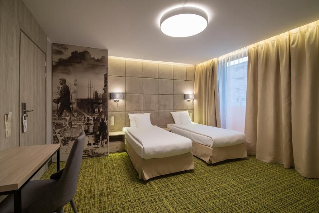 Postel nebo postele na pokoji v ubytování Citi Hotel's Wrocław